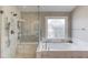 Bright bathroom with large soaking tub and glass shower at 1283 Silver Trace Sw Dr, Lilburn, GA 30047