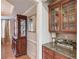 Butler Pantry with granite countertop, cabinets and elegant decor at 1283 Silver Trace Sw Dr, Lilburn, GA 30047