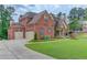 Charming brick home with a three-car garage, landscaped front yard at 1283 Silver Trace Sw Dr, Lilburn, GA 30047