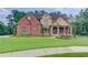 Beautiful brick and stone home with lush lawn and manicured landscaping at 1283 Silver Trace Sw Dr, Lilburn, GA 30047