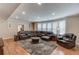 Cozy living room with leather sectional seating and recessed lighting at 1283 Silver Trace Sw Dr, Lilburn, GA 30047