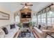 Cozy living room featuring stone fireplace, plantation shutters, and ample natural light at 1283 Silver Trace Sw Dr, Lilburn, GA 30047
