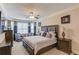 Spacious main bedroom with sitting area, ceiling fan and decorative crown molding at 1283 Silver Trace Sw Dr, Lilburn, GA 30047