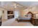 Luxury main bedroom with tray ceiling, fireplace, seating, and large adjoining bath at 1283 Silver Trace Sw Dr, Lilburn, GA 30047