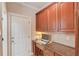 Built-in desk and cabinets provide great home office or study space off kitchen at 1283 Silver Trace Sw Dr, Lilburn, GA 30047