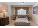 Cozy sitting area with window, curtains, comfortable love seat and a side table at 1283 Silver Trace Sw Dr, Lilburn, GA 30047