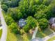 Charming home nestled amongst a wooded lot featuring a circular driveway and well-manicured lawn at 19 Thimblemill Ct, Villa Rica, GA 30180