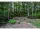 Landscaped backyard with native plants and stone pavers at 19 Thimblemill Ct, Villa Rica, GA 30180