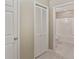 Bright bathroom featuring tile flooring, and an open doorway, with an adjacent closet at 19 Thimblemill Ct, Villa Rica, GA 30180