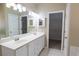 Bathroom showcasing double sinks, a soaking tub, and a walk-in closet at 19 Thimblemill Ct, Villa Rica, GA 30180