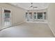 Spacious carpeted bedroom with natural light, a ceiling fan, and a door leading to a deck at 19 Thimblemill Ct, Villa Rica, GA 30180