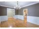 Elegant dining room with beautiful hardwood floors and chandelier at 19 Thimblemill Ct, Villa Rica, GA 30180