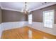 Traditional dining room featuring hardwood floors, white wainscoting, and a decorative chandelier at 19 Thimblemill Ct, Villa Rica, GA 30180