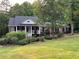 Charming single-story brick home features a covered front porch and lush landscaping at 19 Thimblemill Ct, Villa Rica, GA 30180
