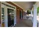 Side view of the covered front porch, with brick facade and ample space at 19 Thimblemill Ct, Villa Rica, GA 30180