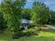 Wide shot of home with beautiful green trees, manicured lawn, and welcoming front entrance at 19 Thimblemill Ct, Villa Rica, GA 30180