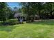 Well-maintained home with a manicured lawn, trees, and inviting front porch at 19 Thimblemill Ct, Villa Rica, GA 30180