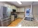 Bright kitchen features stainless steel appliances, granite countertops, light wood floors, and plenty of cabinet space at 19 Thimblemill Ct, Villa Rica, GA 30180