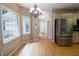 Kitchen area leading into a breakfast nook, featuring stainless steel appliances, a chandelier, and bright natural light at 19 Thimblemill Ct, Villa Rica, GA 30180