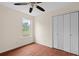 Bedroom featuring hardwood floors, a ceiling fan, closet and a window for natural light at 35 Lady Morgan Ln, Dallas, GA 30157