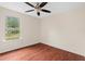 Spacious bedroom featuring hardwood floors and a large window overlooking the neighborhood at 35 Lady Morgan Ln, Dallas, GA 30157