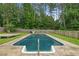 In-ground pool surrounded by a well-maintained backyard with a wooden fence for privacy at 35 Lady Morgan Ln, Dallas, GA 30157