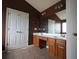 Bathroom featuring a double vanity with oak cabinets and a large mirror at 838 Roxholly Ln, Buford, GA 30518