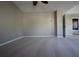 Neutral bedroom with a ceiling fan, neutral-toned walls, carpet, and a view into the bathroom at 838 Roxholly Ln, Buford, GA 30518