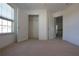 Bedroom with neutral carpet and a window with natural light and open closet with shelving at 838 Roxholly Ln, Buford, GA 30518