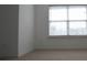 Neutral bedroom with neutral-toned walls, carpet, and a window at 838 Roxholly Ln, Buford, GA 30518