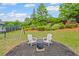 Spacious backyard with a fire pit area, mature trees, and a swing set visible at 121 Bradshaw Park Dr, Woodstock, GA 30188