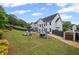 Expansive backyard with a swing set, small storage shed, and black perimeter fencing at 121 Bradshaw Park Dr, Woodstock, GA 30188