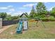 Open backyard with a playset and swing set for to enjoy at 121 Bradshaw Park Dr, Woodstock, GA 30188