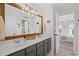 Bathroom featuring a large vanity with double sinks, wooden framed mirror, and a view to the bedroom at 121 Bradshaw Park Dr, Woodstock, GA 30188