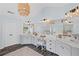 Light-filled primary bathroom boasting dual vanities, a makeup vanity, and stylish modern fixtures at 121 Bradshaw Park Dr, Woodstock, GA 30188
