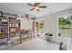 Bright playroom featuring built-in shelving and abundant natural light and view of a lush backyard at 121 Bradshaw Park Dr, Woodstock, GA 30188