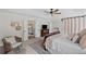 Well-lit primary bedroom featuring a ceiling fan, sitting area, and french doors to the bath at 121 Bradshaw Park Dr, Woodstock, GA 30188