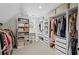Walk-in closet featuring custom organization, ample storage, and a neatly arranged clothing collection at 121 Bradshaw Park Dr, Woodstock, GA 30188