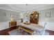 Charming dining room with hardwood floors, a wooden table and bench set, and stylish decor accents at 121 Bradshaw Park Dr, Woodstock, GA 30188