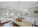 Bright dining room with wainscoting, chandelier lighting, and hardwood floors at 121 Bradshaw Park Dr, Woodstock, GA 30188
