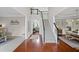 Inviting foyer with hardwood floors, a staircase with iron balusters, and views into the living and dining areas at 121 Bradshaw Park Dr, Woodstock, GA 30188