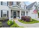 Charming front porch adorned with a wreath, plants, and an American flag, creating a welcoming entrance at 121 Bradshaw Park Dr, Woodstock, GA 30188