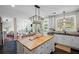 Open kitchen with a large island and a view into the living space and backyard at 121 Bradshaw Park Dr, Woodstock, GA 30188