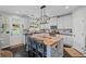 Well-lit kitchen with white cabinets, stainless appliances, and a butcher block island at 121 Bradshaw Park Dr, Woodstock, GA 30188