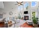 Spacious living room featuring a fireplace, high ceilings, and large windows at 121 Bradshaw Park Dr, Woodstock, GA 30188