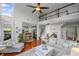 Inviting living room with hardwood floors, comfortable seating, and a view of the upstairs balcony at 121 Bradshaw Park Dr, Woodstock, GA 30188