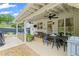 Spacious covered patio provides multiple seating areas for relaxation and outdoor enjoyment at 121 Bradshaw Park Dr, Woodstock, GA 30188