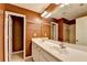 A bathroom with double vanity with a large mirror and white cabinets, plus an adjoined toilet area and shower at 2008 Hailston Dr, Duluth, GA 30097