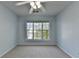 A bright bedroom with a ceiling fan has a window letting in natural light with neutral colored carpet at 2008 Hailston Dr, Duluth, GA 30097
