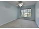 A bright bedroom with a ceiling fan has a window letting in natural light with neutral colored carpet at 2008 Hailston Dr, Duluth, GA 30097